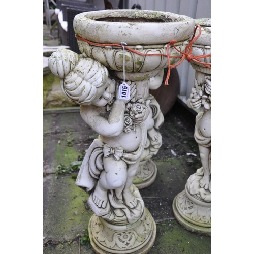 1015 - THREE COMPOSITE PLANTERS, of three cherubs that are each holding a bowl aloft, diameter 38cm x heigh... 