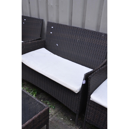 1017 - AN UNBRANDED FAUX RATTAN FOUR PIECE GARDEN SET, comprising a two seater sofa, length 104cm, pair of ... 