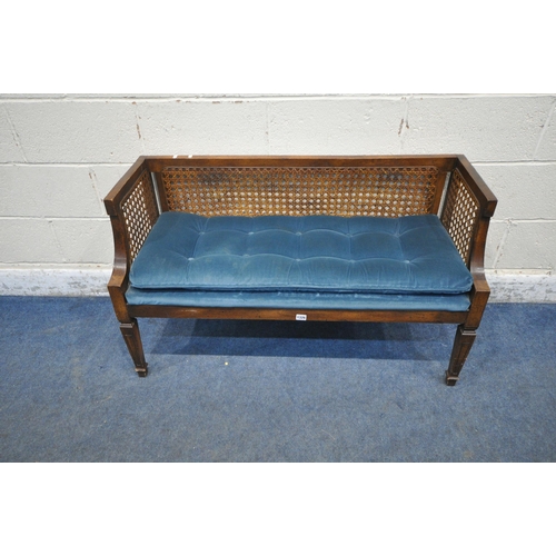 1326 - A LATE 20TH CENTURY WINDOW SEAT, with cane back and sides, blue upholstered seat, raised on square t... 