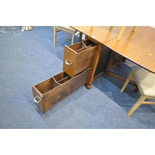 1338 - A 20TH CENTURY OAK DROP LEAF TABLE, with two drawers, raised on castors, open width 149cm x depth 10... 