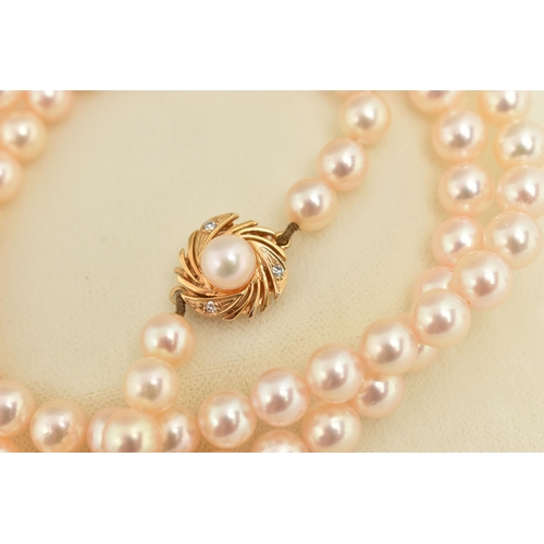 15 - A CULTURED PEARL NECKLACE, a long string of cultured pearls, approximate pearl diameter 6.7mm, fitte... 