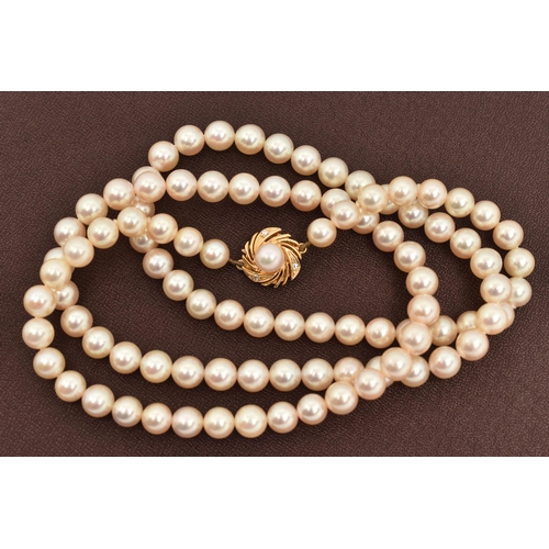 15 - A CULTURED PEARL NECKLACE, a long string of cultured pearls, approximate pearl diameter 6.7mm, fitte... 