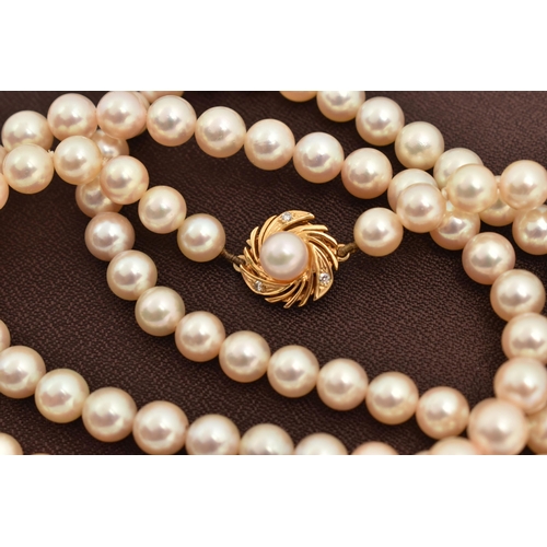 15 - A CULTURED PEARL NECKLACE, a long string of cultured pearls, approximate pearl diameter 6.7mm, fitte... 