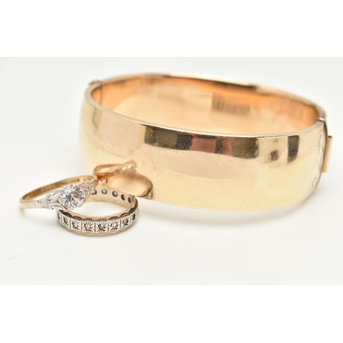 26 - A ROLLED GOLD HINGED BANGLE AND TWO RINGS, the wide foliate designed hinged bangle fitted with a pus... 