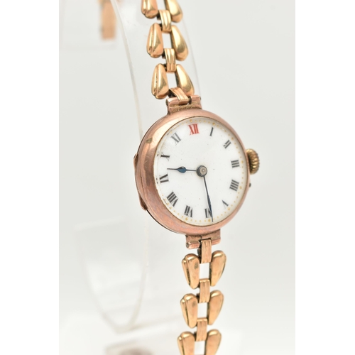 33 - A 9CT GOLD LADIES WRISTWATCH, hand wound movement, round white dial, Roman numerals, rose gold case,... 