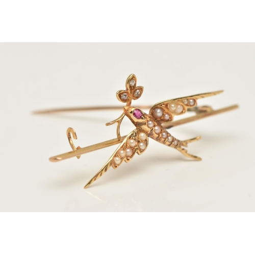 45 - AN EARLY 20TH CENTURY YELLOW METAL SWALLOW BIRD BROOCH, depicting a flying swallow bird set with spl... 