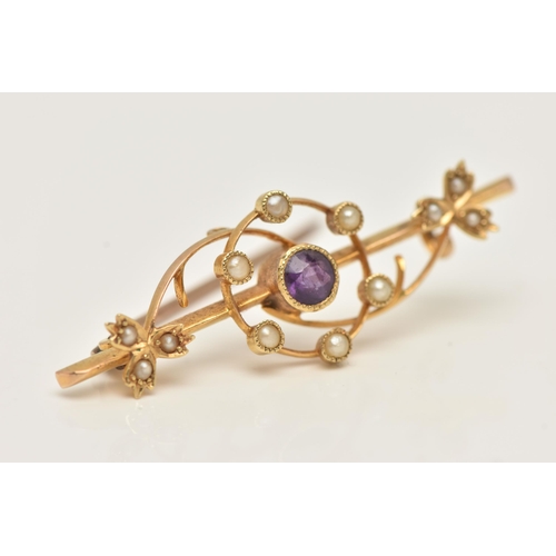 65 - AN EARLY 20TH CENTURY BAR BROOCH, a yellow metal brooch principally set with a circular cut amethyst... 