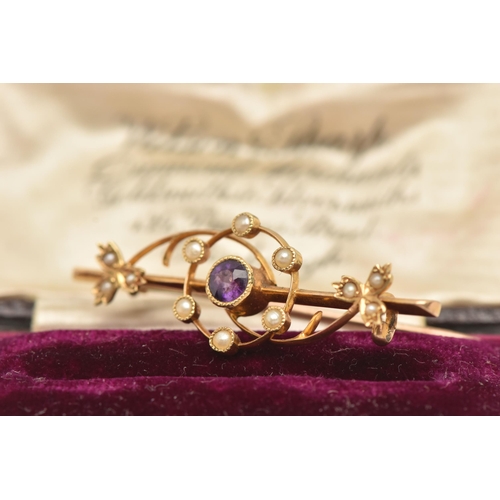 65 - AN EARLY 20TH CENTURY BAR BROOCH, a yellow metal brooch principally set with a circular cut amethyst... 