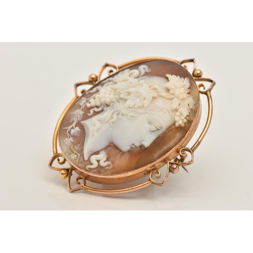 67 - A SHELL CAMEO BROOCH, an oval form shell cameo depicting a Grecian lady, collet set in yellow metal ... 