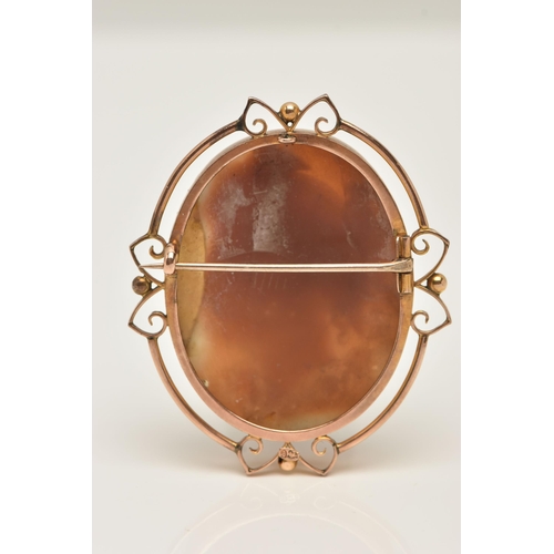 67 - A SHELL CAMEO BROOCH, an oval form shell cameo depicting a Grecian lady, collet set in yellow metal ... 