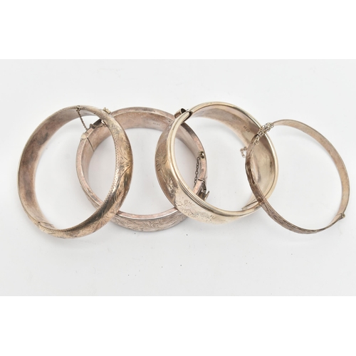 115 - THREE SILVER BANGLES AND A WHITE METAL BANGLE, a wide hinged bangle, etched with scrolling acanthus ... 