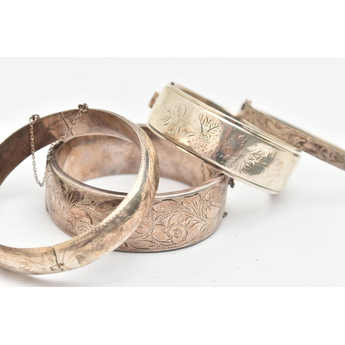 115 - THREE SILVER BANGLES AND A WHITE METAL BANGLE, a wide hinged bangle, etched with scrolling acanthus ... 