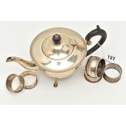 127 - AN EARLY 20TH CENTURY SILVER TEAPOT AND FIVE NAPKIN RINGS, polished teapot with beaded rim, raised o... 