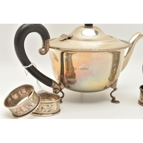 127 - AN EARLY 20TH CENTURY SILVER TEAPOT AND FIVE NAPKIN RINGS, polished teapot with beaded rim, raised o... 