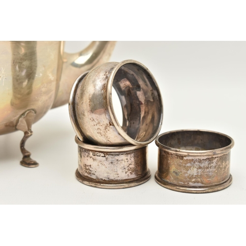 127 - AN EARLY 20TH CENTURY SILVER TEAPOT AND FIVE NAPKIN RINGS, polished teapot with beaded rim, raised o... 