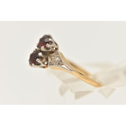 76 - A YELLOW METAL AND GARNET RING, set with two circular cut garnets each in an eight claw white metal ... 