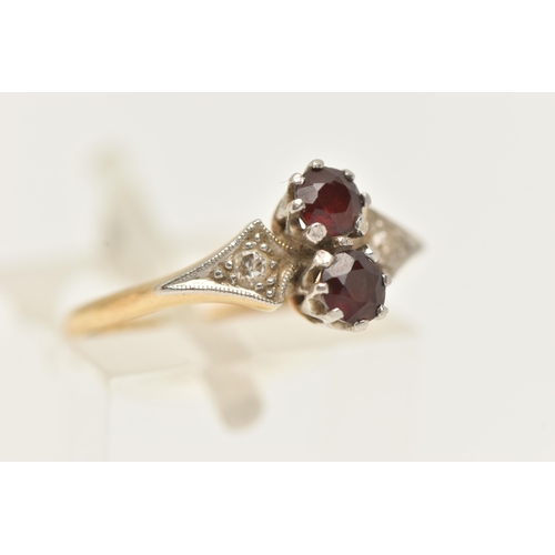 76 - A YELLOW METAL AND GARNET RING, set with two circular cut garnets each in an eight claw white metal ... 