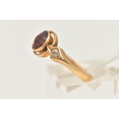 77 - A 22CT GOLD GEM SET RING, set with a central circular cut red stone assessed as garnet, collet set w... 