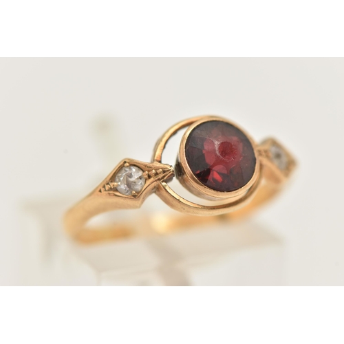 77 - A 22CT GOLD GEM SET RING, set with a central circular cut red stone assessed as garnet, collet set w... 