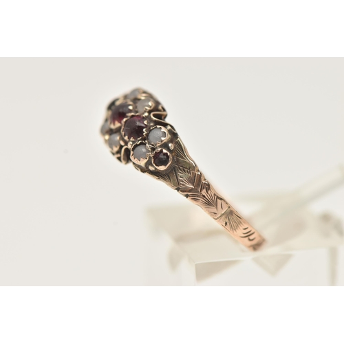 78 - A LATE VICTORIAN 9CT GOLD RING, set with five graduating very worn red paste stones, within a surrou... 