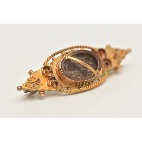 84 - A 9CT GOLD HAIR PIECE BROOCH, set with a central oval panel with brown woven hair, beneath a glazed ... 