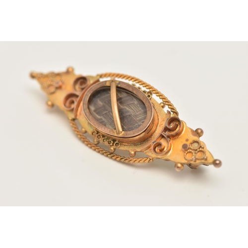 84 - A 9CT GOLD HAIR PIECE BROOCH, set with a central oval panel with brown woven hair, beneath a glazed ... 