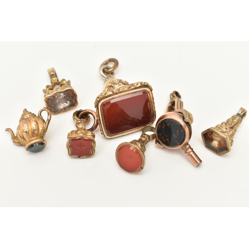 86 - A SELECTION OF GOLD PLATED FOB SEALS, A SWIVEL WATCH KEY AND A CHARM, to include a larger square sha... 