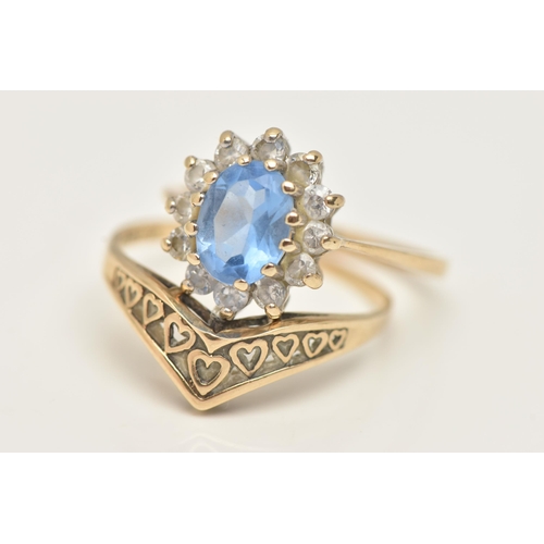 96 - TWO 9CT GOLD RINGS, the first an oval cluster ring, set with a central oval cut light blue stone and... 