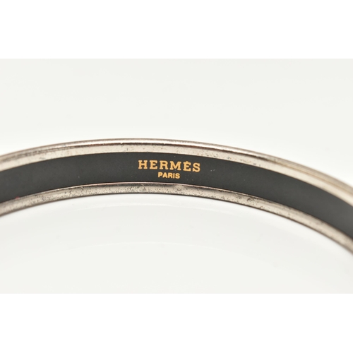 181 - A 'HERMES' BANGLE, designed as a solid silver plated bangle with enamel alphabet and number detail, ... 