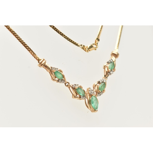 183 - A YELLOW METAL GEM SET NECKLACE, a V shape necklace comprised of five marquise cut emeralds and nine... 