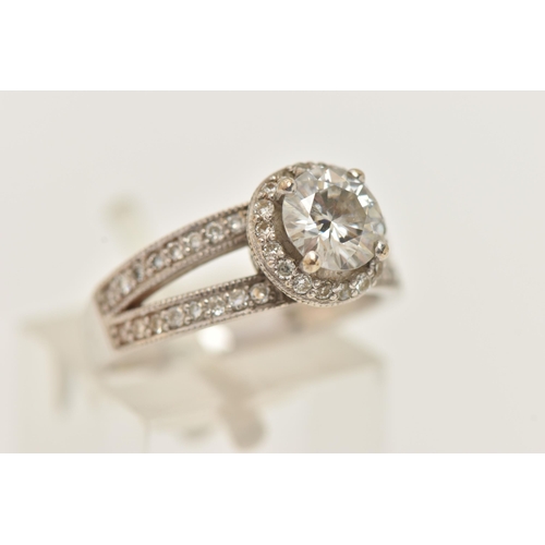 184 - A 9CT GOLD CUBIC ZIRCONIA RING, a circular cut cubic zirconia, additional cubic zirconia set halo le... 