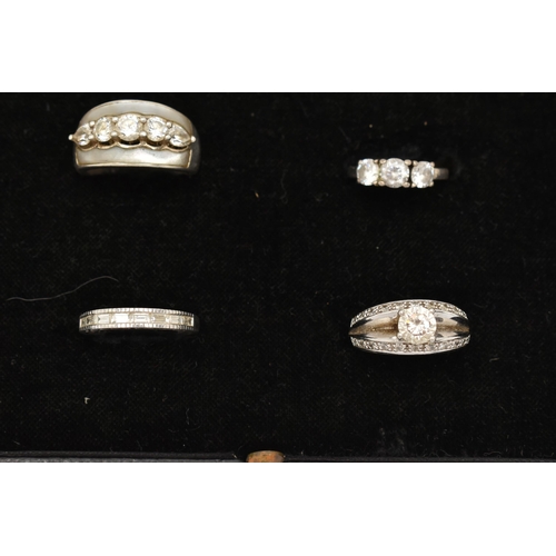 186 - TWELVE WHITE METAL RINGS, twelve white metal dress rings, some set with cubic zirconia, each stamped... 