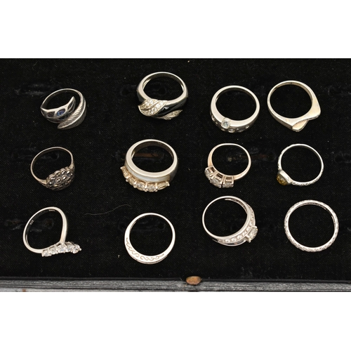 186 - TWELVE WHITE METAL RINGS, twelve white metal dress rings, some set with cubic zirconia, each stamped... 