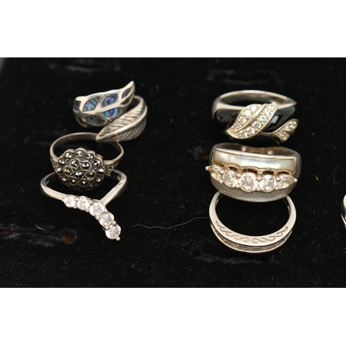 186 - TWELVE WHITE METAL RINGS, twelve white metal dress rings, some set with cubic zirconia, each stamped... 