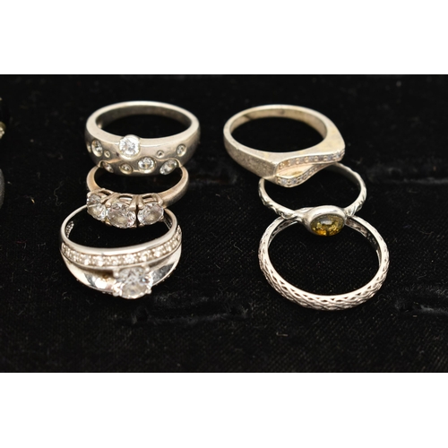 186 - TWELVE WHITE METAL RINGS, twelve white metal dress rings, some set with cubic zirconia, each stamped... 