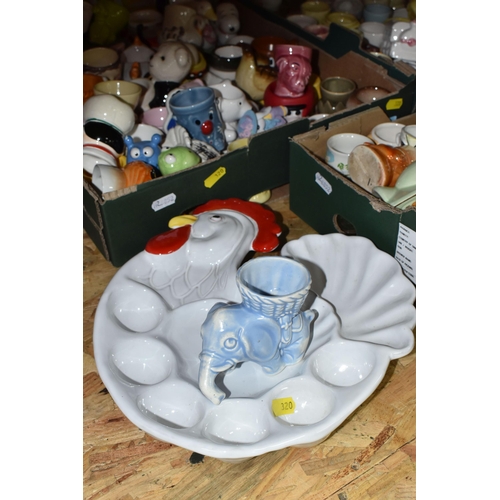 320 - THREE BOXES CONTAINING A COLLECTION OF EGG CUPS, to include two egg platters, approximately two hund... 