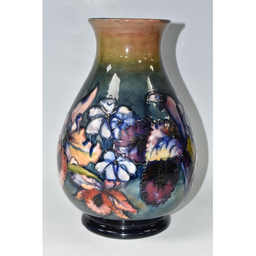 351 - A LARGE MOORCROFT POTTERY ORCHID PATTERN VASE, the baluster vase tube lined in the Orchid pattern on... 