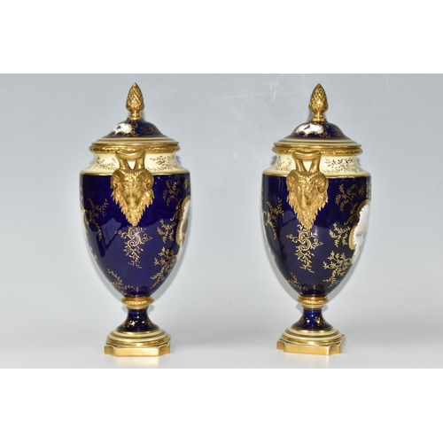 362 - A PAIR OF COALPORT COVERED VASES, of urn form with twin gilt ram's head handles, on a square pedesta... 