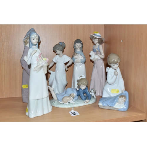 389 - A GROUP OF SEVEN LLADRO, NAO, AND SIMILAR FIGURES to include two Lladro figurines comprising 'Playfu... 