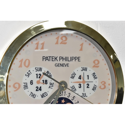 398 - A DISPLAY WALL CLOCK with a printed clock face marked 'Patek Philippe Geneve Swiss Made' with printe... 