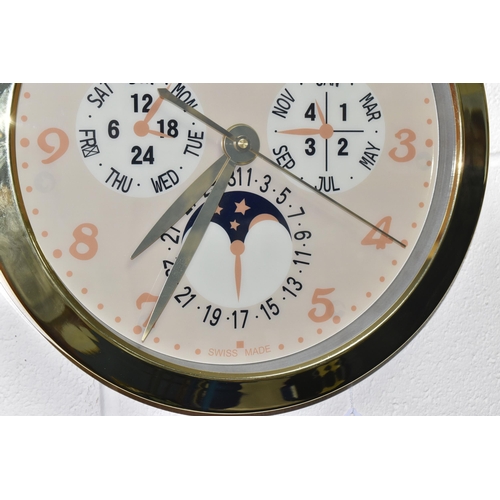 398 - A DISPLAY WALL CLOCK with a printed clock face marked 'Patek Philippe Geneve Swiss Made' with printe... 