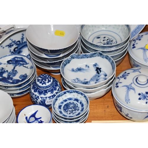 402 - A LARGE QUANTITY OF BLUE AND WHITE MOSTLY CHINESE CERAMICS to include three blue and white bowls wit... 