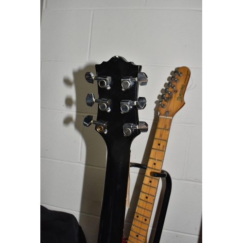 406 - TWO ELECTRIC GUITARS comprising an Ibanez 'Roadstar II' marked H831252 to the reverse, red body with... 