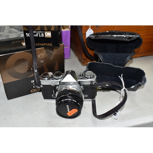 416 - A BOXED OLYMPUS OM-1 AND LENSES comprising an Olympus OM-1 body with original box fitted with a Zuik... 