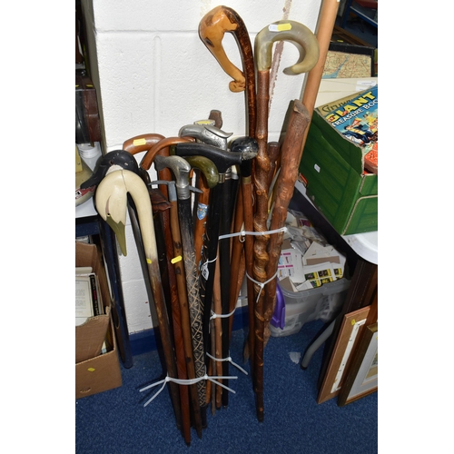 428 - A COLLECTION OF WALKING STICKS, twenty five sticks to include two sticks with handles in the form of... 