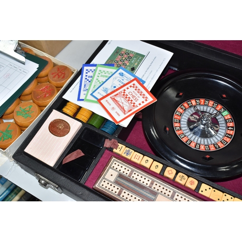 499 - A K & C LTD BOX SET OF TABLE GAMES comprising a roulette wheel, dominoes, chess pieces, draughts pie... 