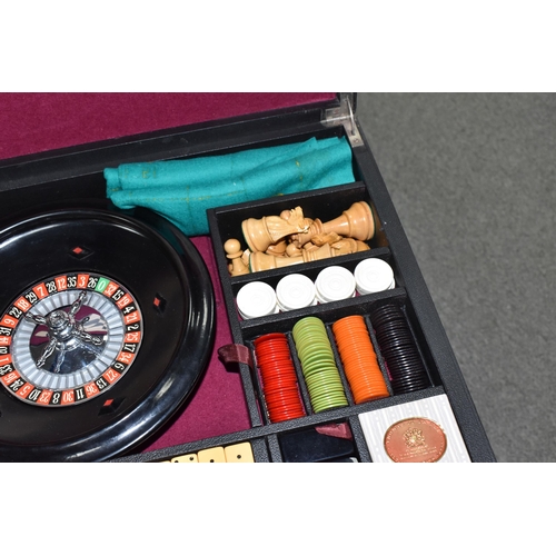 499 - A K & C LTD BOX SET OF TABLE GAMES comprising a roulette wheel, dominoes, chess pieces, draughts pie... 