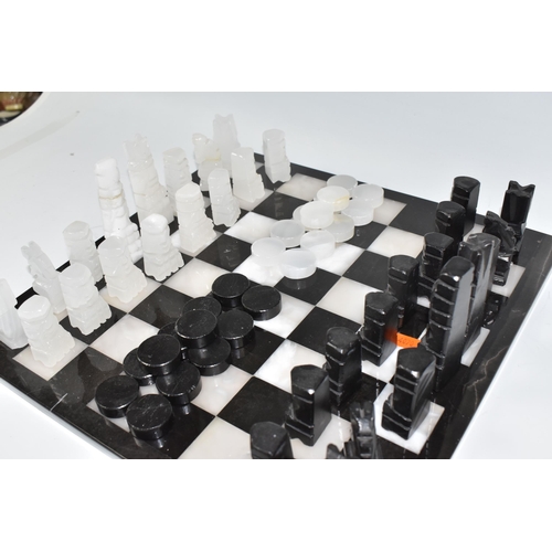 503 - A BLACK AND WHITE ONYX 'ABSTRACT AZTEC' CHESS SET with thirty-two chess pieces on a matching board, ... 