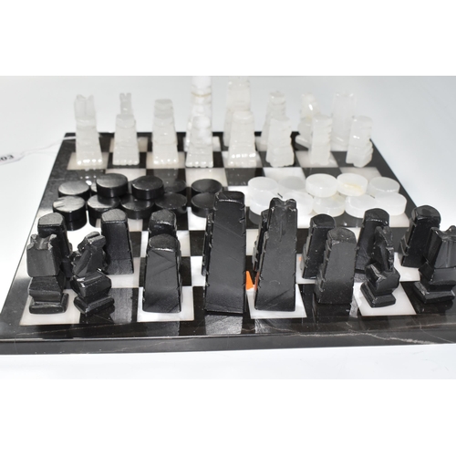 503 - A BLACK AND WHITE ONYX 'ABSTRACT AZTEC' CHESS SET with thirty-two chess pieces on a matching board, ... 