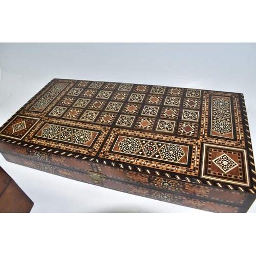 505 - TWO MIDDLE EASTERN BACKGAMMON BOARDS, comprising a large 1970's inlaid games box with chess board to... 